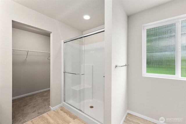 19504 15th Ave E, Spanaway, WA 98387 - bathroom featuring a stall shower, a spacious closet, healthy amount of natural light, and recessed lighting