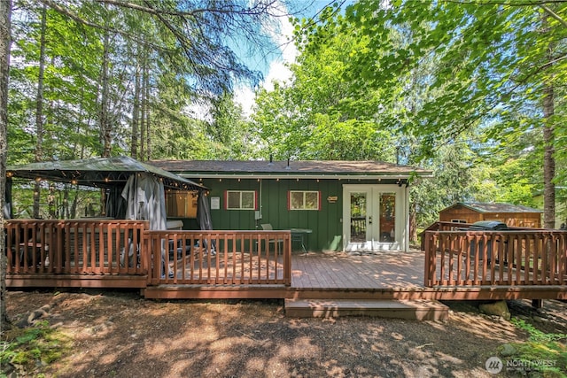 105 Robinwood Pl, Packwood, WA 98361 - rear view of property featuring a wooden deck, a gazebo, board and batten siding, and french doors
