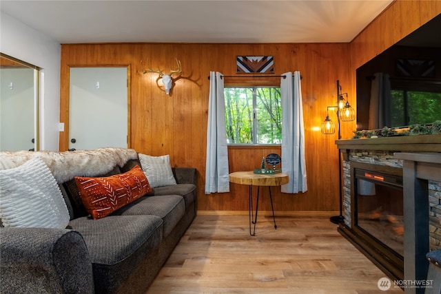 105 Robinwood Pl, Packwood, WA 98361 - living room featuring wooden walls, a stone fireplace, and wood finished floors