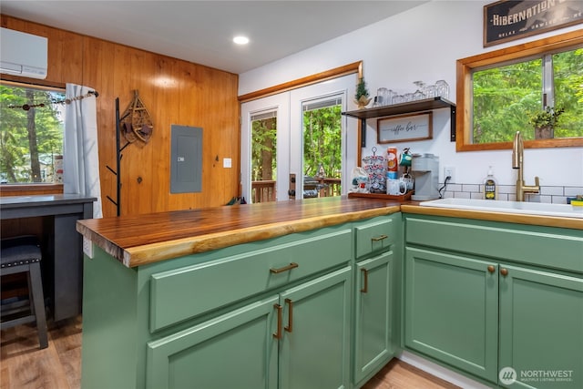 105 Robinwood Pl, Packwood, WA 98361 - kitchen with electric panel, an AC wall unit, a sink, plenty of natural light, and green cabinets