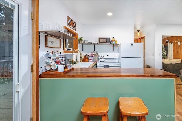 105 Robinwood Pl, Packwood, WA 98361 - kitchen with recessed lighting, open shelves, a sink, white appliances, and a peninsula