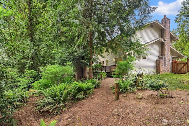 view of yard featuring fence and a wooden deck