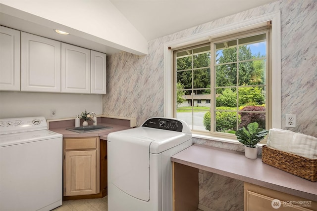 laundry area with cabinet space, washer and clothes dryer, and wallpapered walls