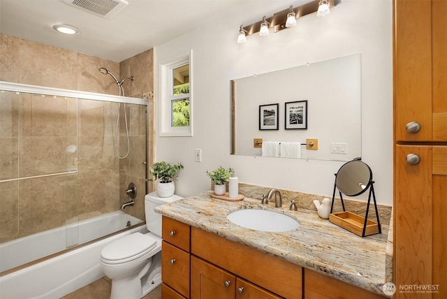 full bath featuring toilet, vanity, and bathtub / shower combination