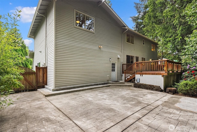 rear view of house with a patio area and a deck