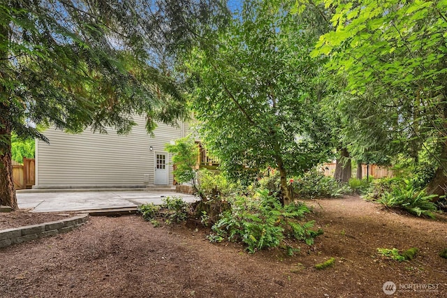 view of yard featuring fence and a patio area