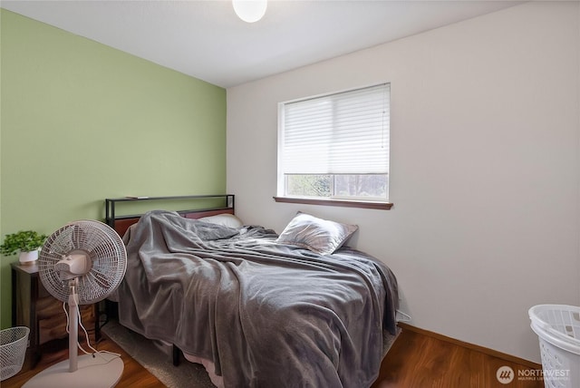 bedroom featuring baseboards and wood finished floors