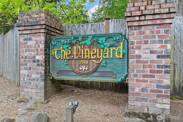 community sign featuring fence
