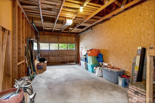 garage featuring a textured wall and a garage door opener