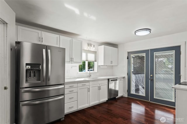 kitchen featuring dark wood finished floors, appliances with stainless steel finishes, french doors, and white cabinets