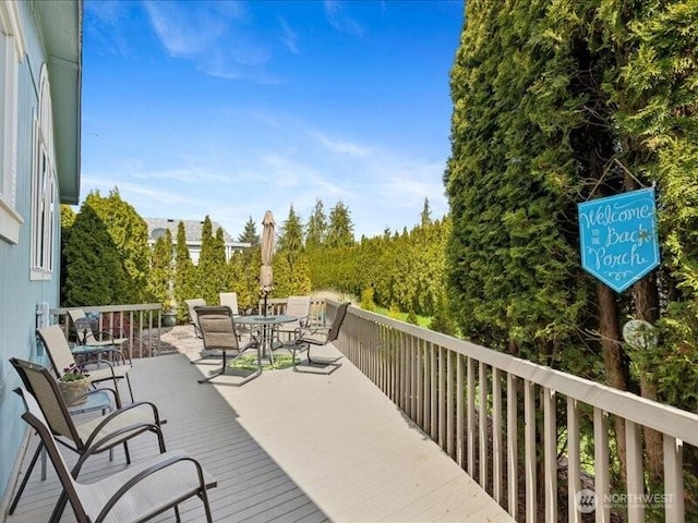 wooden deck with outdoor dining space