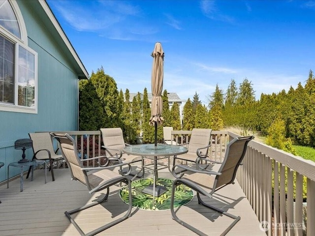 wooden terrace with outdoor dining space