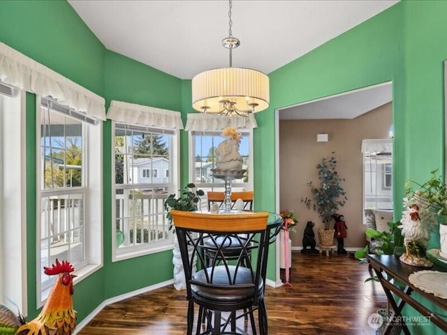dining space featuring baseboards and dark wood-style flooring