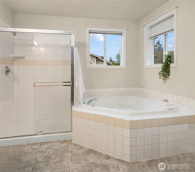 full bathroom with plenty of natural light, a stall shower, and a garden tub