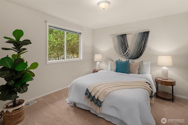 carpeted bedroom featuring visible vents and baseboards