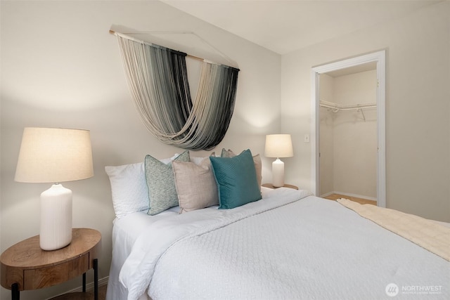 bedroom with baseboards and a closet