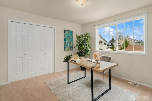 carpeted home office featuring baseboards and visible vents