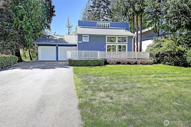 366 Tillicum Way, Camano Island, WA 98282 - mid-century inspired home with covered porch, driveway, a garage, a front lawn, and a shingled roof