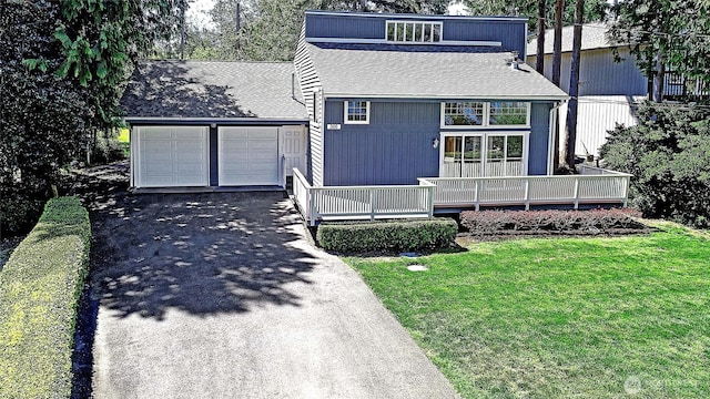 366 Tillicum Way, Camano Island, WA 98282 - view of front of property featuring driveway, roof with shingles, a front lawn, and a garage
