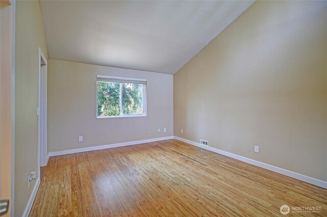 366 Tillicum Way, Camano Island, WA 98282 - empty room featuring lofted ceiling, hardwood / wood-style floors, visible vents, and baseboards