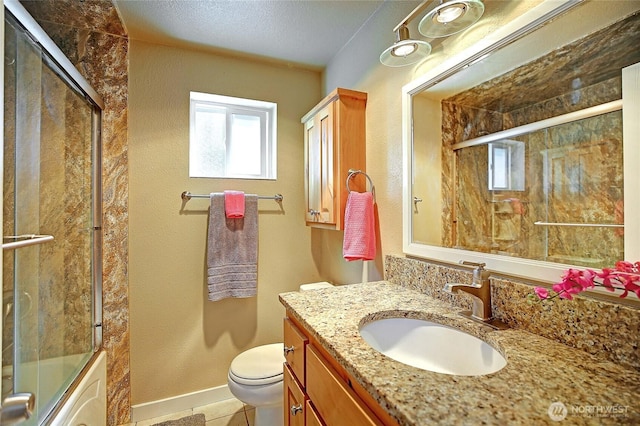 366 Tillicum Way, Camano Island, WA 98282 - full bathroom with toilet, baseboards, shower / bath combination with glass door, tile patterned floors, and vanity