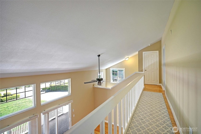 366 Tillicum Way, Camano Island, WA 98282 - corridor with vaulted ceiling, a textured ceiling, and light wood-type flooring