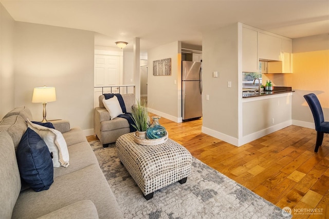 living room with light wood-style floors and baseboards