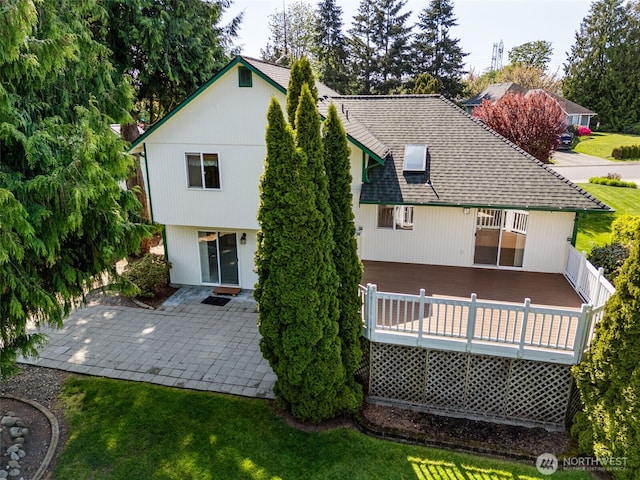back of property featuring a patio area, a yard, and a deck