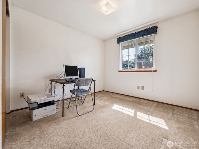 carpeted home office featuring baseboards