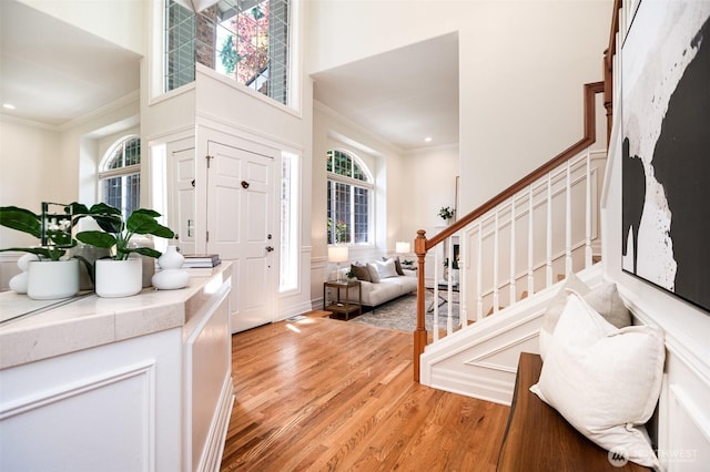 11628 NE 100th St, Kirkland, WA 98033 - foyer featuring ornamental molding, stairs, light wood-type flooring, a towering ceiling, and recessed lighting