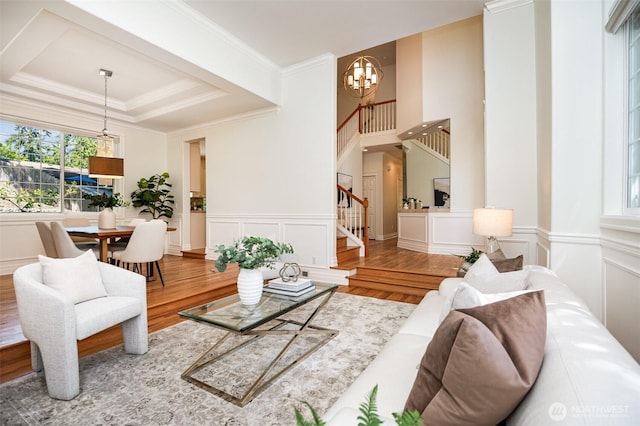 11628 NE 100th St, Kirkland, WA 98033 - living area featuring plenty of natural light, wood finished floors, a chandelier, stairs, and a decorative wall