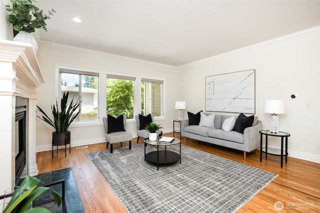 11628 NE 100th St, Kirkland, WA 98033 - living room featuring baseboards, wood finished floors, crown molding, a fireplace, and recessed lighting