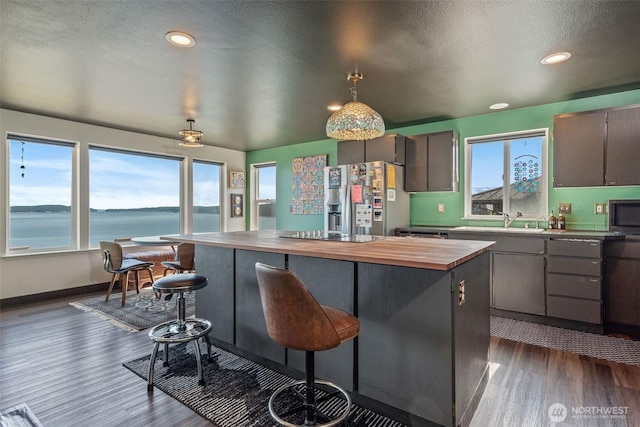51 Vista Blvd, Port Townsend, WA 98368 - kitchen with a center island, a sink, wooden counters, dark wood finished floors, and appliances with stainless steel finishes