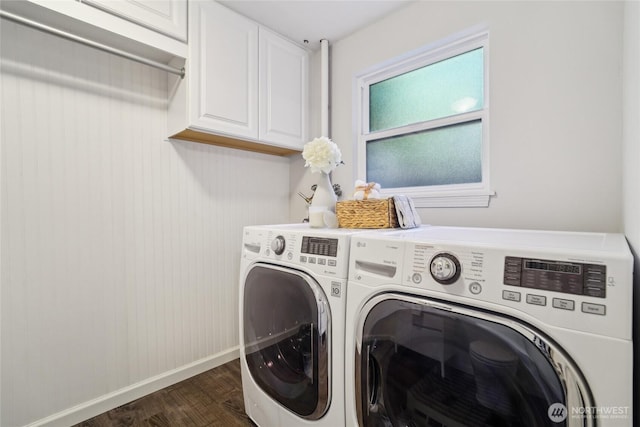 laundry room featuring washing machine and clothes dryer, baseboards, dark wood-style floors, and cabinet space