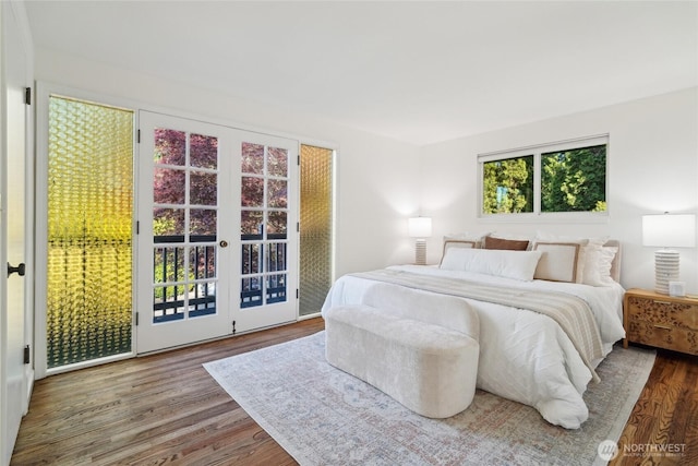 bedroom featuring access to exterior and wood finished floors