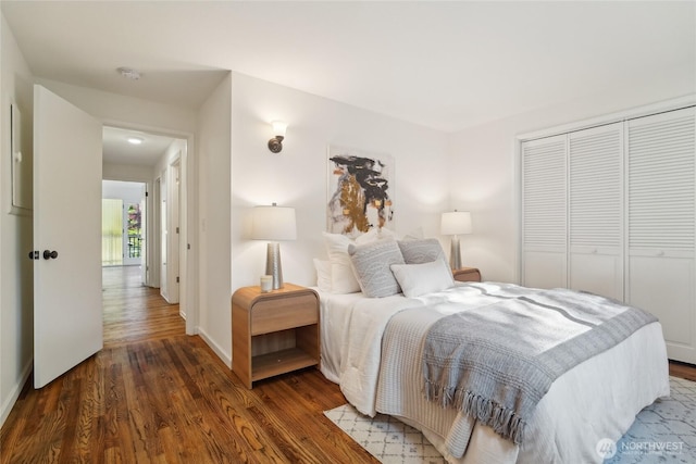 bedroom featuring baseboards, a closet, and wood finished floors