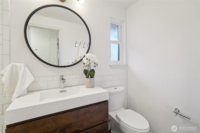half bathroom featuring vanity and toilet