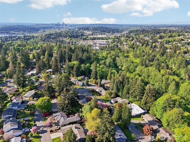 drone / aerial view with a forest view and a residential view