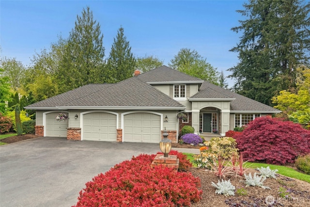 26006 NE 27th Dr, Redmond, WA 98053 - view of front of home with an attached garage, roof with shingles, driveway, and brick siding
