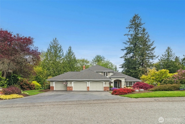 26006 NE 27th Dr, Redmond, WA 98053 - view of front facade with a garage, a chimney, and aphalt driveway