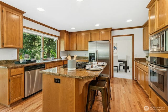 26006 NE 27th Dr, Redmond, WA 98053 - kitchen featuring appliances with stainless steel finishes, ornamental molding, a sink, and light wood-style flooring