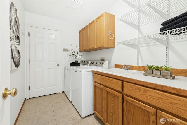 26006 NE 27th Dr, Redmond, WA 98053 - laundry area featuring cabinet space, a sink, separate washer and dryer, baseboards, and light tile patterned floors