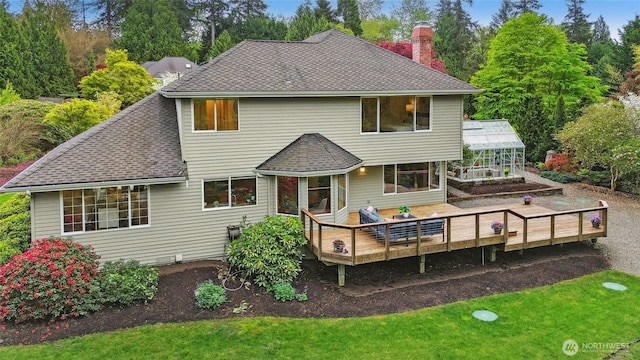26006 NE 27th Dr, Redmond, WA 98053 - back of house with roof with shingles, a chimney, a yard, and a deck