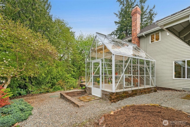 26006 NE 27th Dr, Redmond, WA 98053 - back of house featuring an exterior structure, an outbuilding, and a chimney