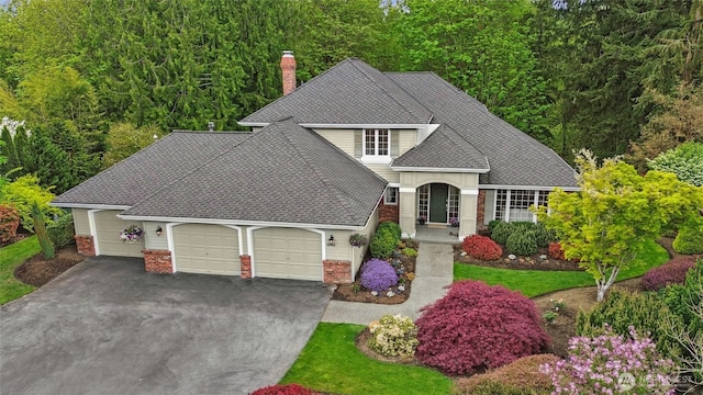26006 NE 27th Dr, Redmond, WA 98053 - view of front of property with brick siding, an attached garage, a chimney, and roof with shingles