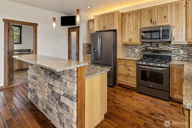 kitchen featuring light brown cabinetry, dark wood-style flooring, appliances with stainless steel finishes, and decorative backsplash