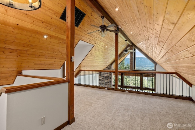 additional living space featuring carpet flooring, a ceiling fan, wooden ceiling, and vaulted ceiling with beams