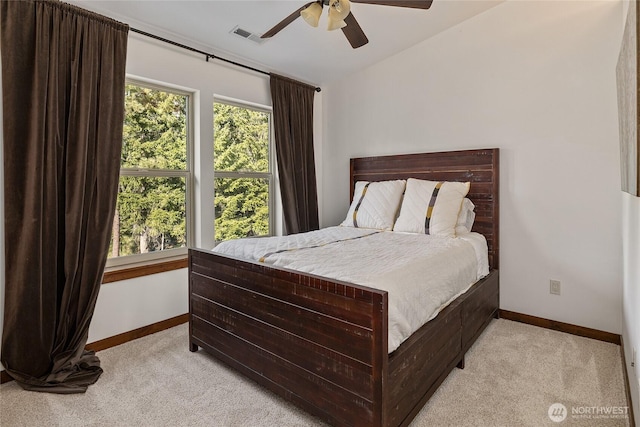 bedroom with visible vents, ceiling fan, light carpet, and baseboards