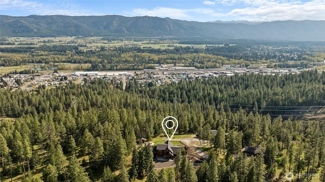 bird's eye view with a mountain view and a wooded view