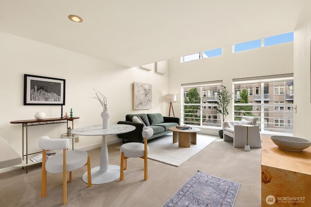 living area with recessed lighting, baseboards, and carpet